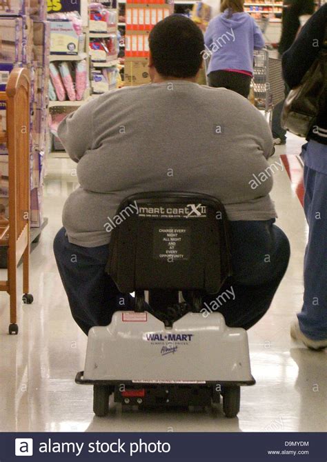 Huge Obese American Disabled Man Shopping In Wal Mart Driving A Stock
