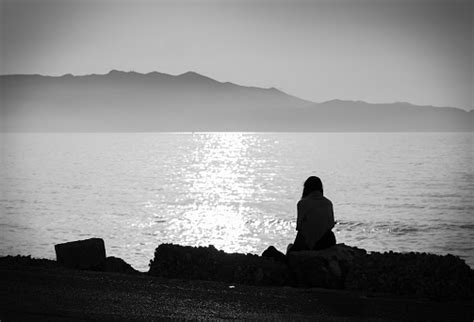 Depression Black And White Photo Of A Melancholic Girl Sitting Alone By