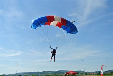 Parachuter Skydiver Jumping And Skydiving With Blue Red White Colours