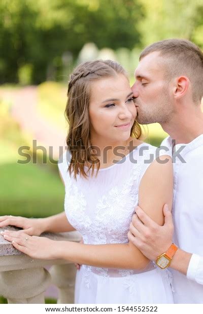 Happy Groom Kissing Bride Outside Concept Stock Photo 1544552522