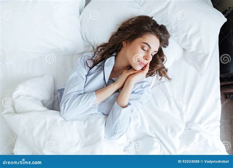 Top View Of Young Beautiful Woman In Pajamas Sleeping Peacefully Stock