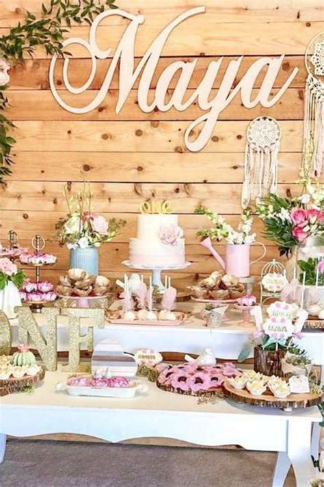 A Table Topped With Cakes And Desserts Covered In Frosted Icing Next To