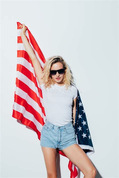 American Blonde Woman Holding The Usa Flag Isolated Over A White Background Stock Image Image
