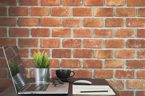 Premium Photo Desk Of Work Table On Brick Wall Background In Office