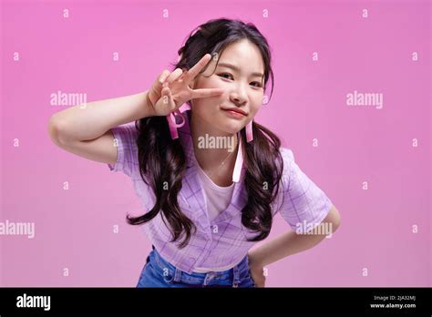 Mz Generation Cute Asian Korean Girl With V Shaped Finger Pose Stock