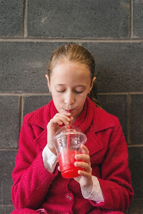 Girl Drinking Red Slushie Drink Del Colaborador De Stocksy Gillian