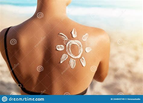 Sun Protection Sun Cream Woman Applying Sun Cream On Tanned Shoulder In Form Of The Sun Skin