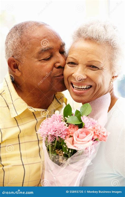 Senior Man Giving Flowers To Wife Stock Image Image Of Kissing Love 55893735