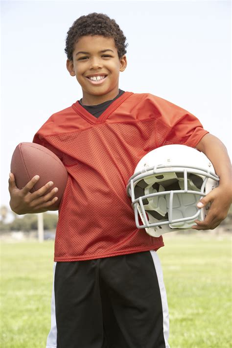 Young Boy Playing American Football The Community Caring Collaborative