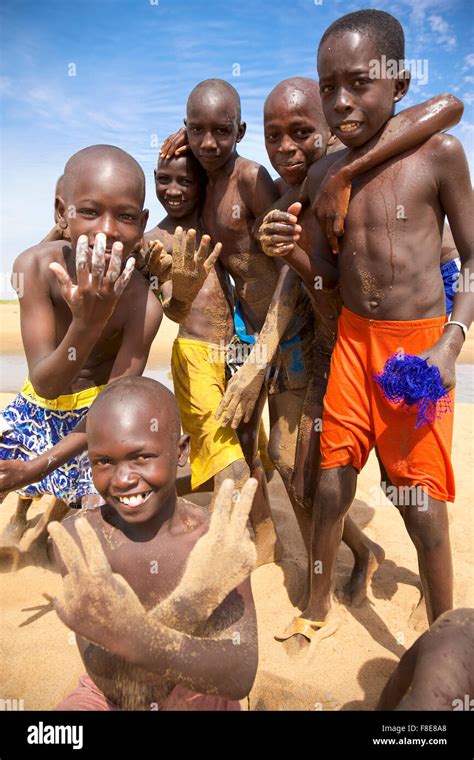 Young African Group Of Kids Playing On The Beach And Smiling Senegal