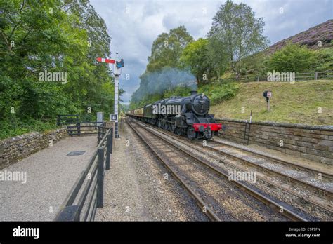 Steam Train And Carriages Travelling On Heritage Railway From