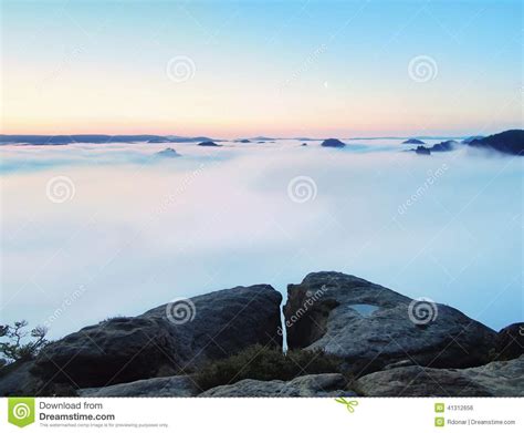 Blue Misty Morning View Over Rock To Deep Valley Full Of