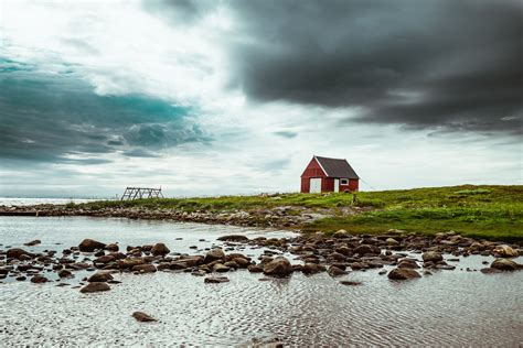 Red And Gray Barn Near Body Of Water · Free Stock Photo