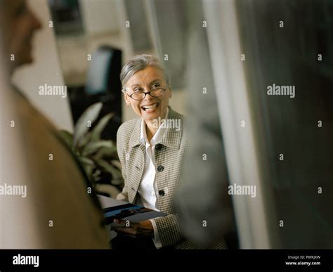 Secretary Laughing With Her Co Worker Stock Photo Alamy