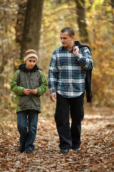 father and son taking a walk outdoor stock image image of trees portrait 16865153