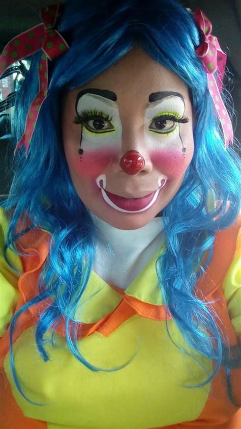 A Woman With Blue Hair And Clown Makeup