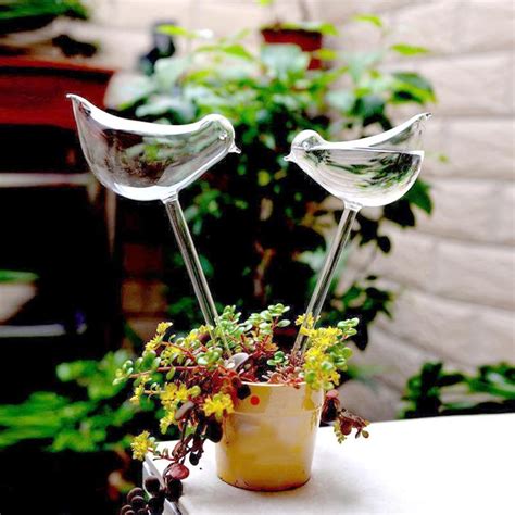 With your thumb pressed over the mouth of the bottle, flip it upside down and press the neck into the soil. Birds Shape House Plants Flowers Water Feeder Automatic Self Watering Devices Clear Glass Water ...