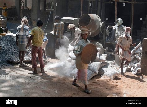 Indian Construction Workers Mixing Rock Sand And Cement To Make