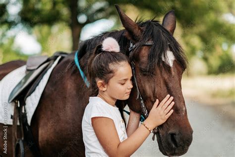 Friendship Of A Child With A Horse A Little Girl Is Affectionately