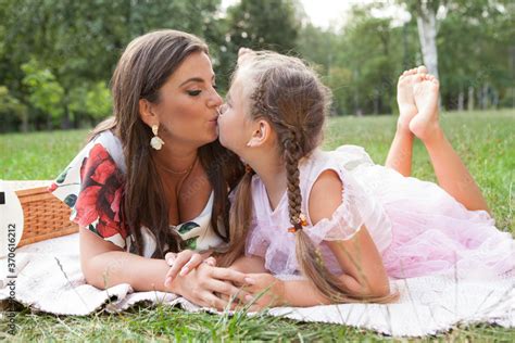 Mother And Daughter Kissing On The Lips Having Fun On A Picnic At The Park Stock Foto Adobe Stock
