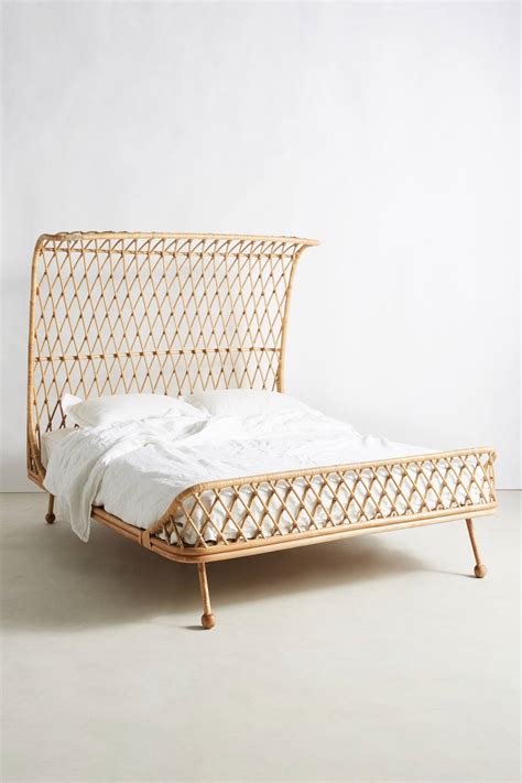 The angular headboard is upholstered in a double layer of rattan and. Curved Rattan Bed | Anthropologie