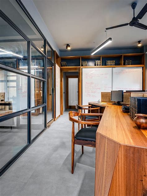 An Office With Wooden Furniture And Glass Walls