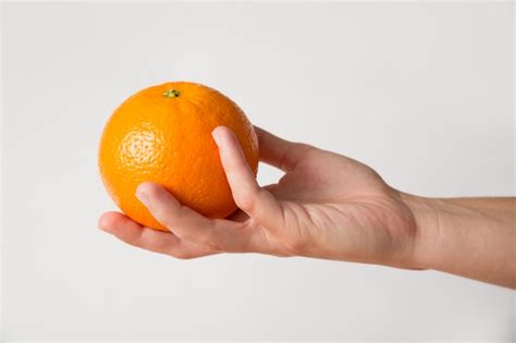 Person Giving Orange Free Photo