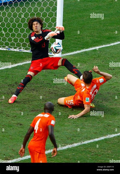 Mexico S Goalkeeper Guillermo Ochoa Saves A Goal Shot By Klaas Jan Huntelaar Of The Netherlands