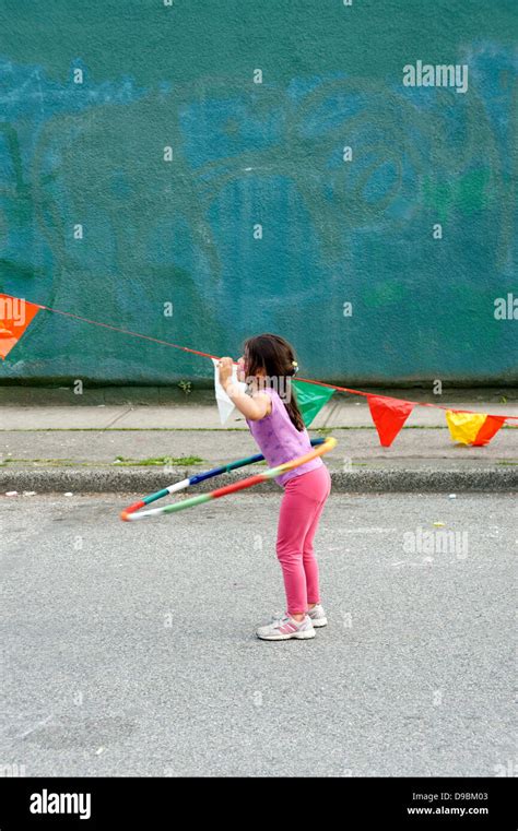 Young Girl Twirling A Hula Hoop At The Car Free Day Festival On Main
