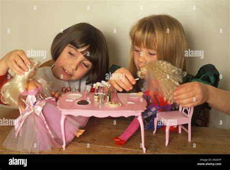 Little Girls Playing With Their Barbie Dolls Stock Photo Alamy