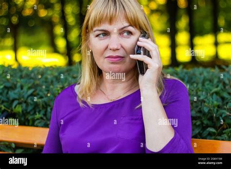 defocus beautiful caucasian blond woman talking speaking on the phone outside outdoor 45s