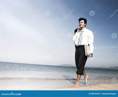 Businessman Walking Along A Beach With Laptop Stock Photo Image Of