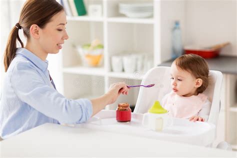 Happy Mother Feeding Baby With Puree At Home Stock Photo Image Of