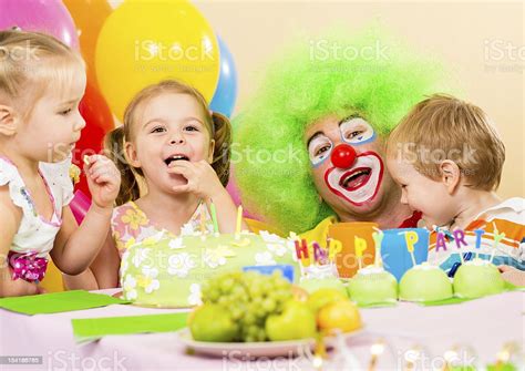 Kids Celebrating Birthday Party With Clown Stock Photo Download Image