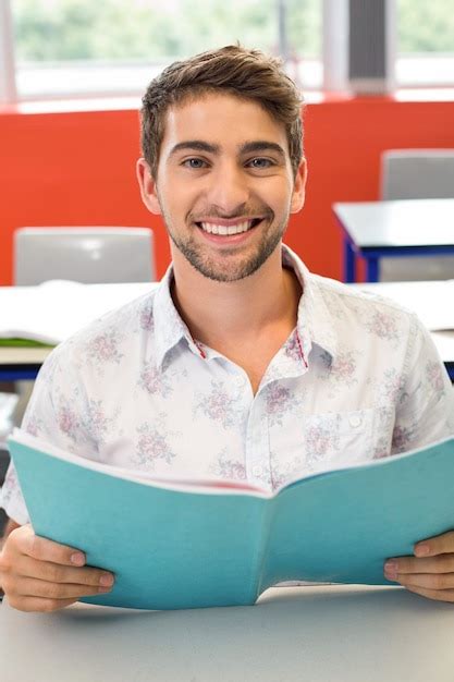 Premium Photo Male Student Reading Notes In Classroom