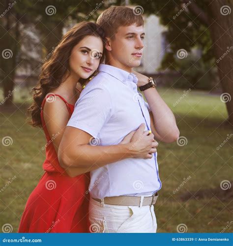 Beautiful Brunette Couple In Love Hugging On A Date In The Park Stock
