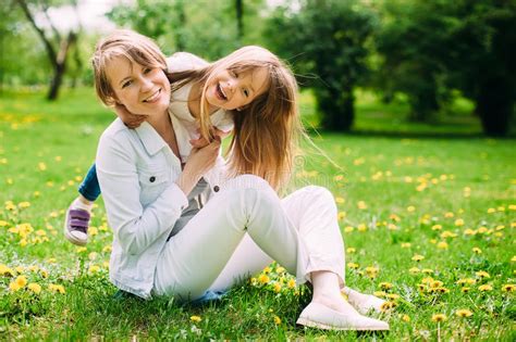 Hugging Happy Mother And Daughter For A Walk In The Park On The Green Lawn Stock Image Image