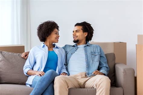 Happy Couple Sitting On Sofa And Talking At Home Stock Photo Image Of