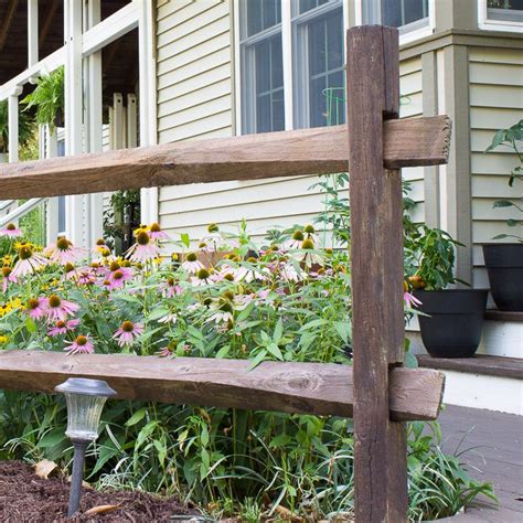 A general view of a back garden lawn with grey wood fences of a home. How to Stain a Split Rail Fence | Wagner SprayTech ...