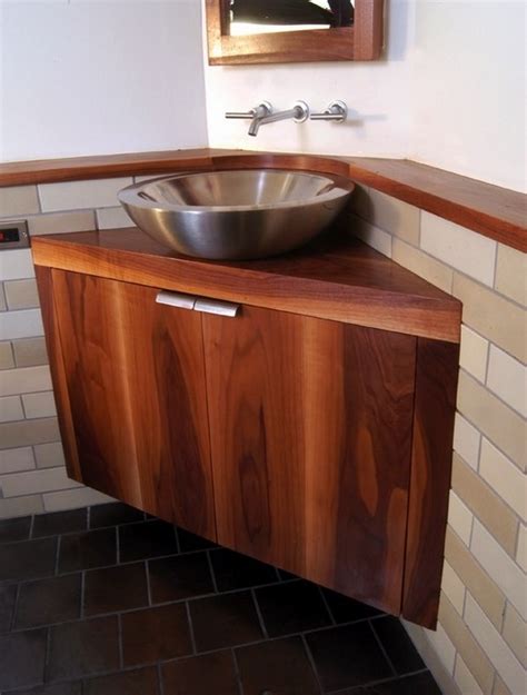 Corner bathroom vanities in larger bathrooms help to add counter space. Vessel sinks are the hot trend in bathroom design
