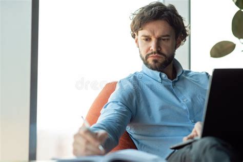 Portrait Of Focused Man Using Laptop And Writing Stock Photo Image Of