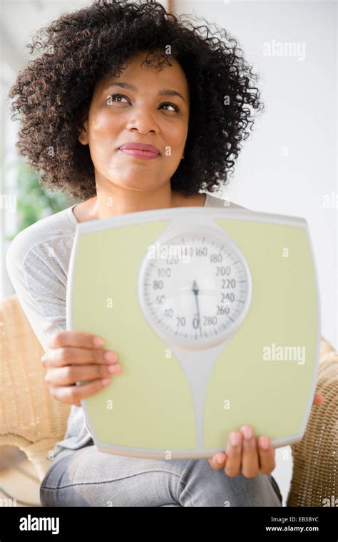 Smiling Woman Holding Scale Stock Photo Alamy