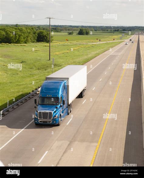 Blue Semi Truck Trailer Rig Hauls Freight On Divided Highway Stock