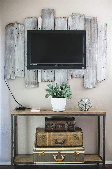 I decided to disguise it by decorating the wall behind it using floor to ceiling shims. Remodelaholic | 95 Ways to Hide or Decorate Around the TV, Electronics, and Cords