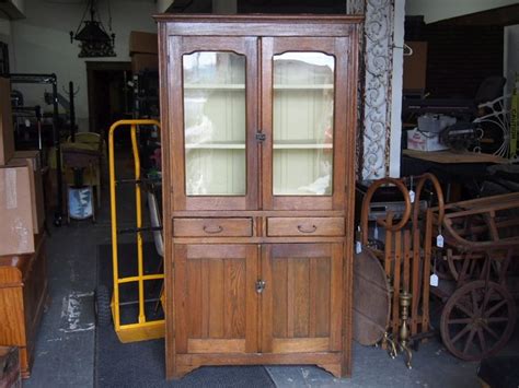 Living room, bedroom, dining room, patio and garden, kitchen Antique Oak Cabinet With old, wavy glass doors. Bail handles. A good looking country style piece ...