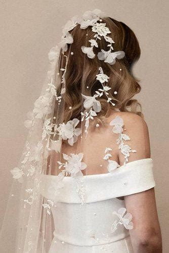 Bridal wedding veil coming out of elaborate, fancy bride updo. 42 Dreamy Wedding Hairstyles With Veil | Wedding Forward