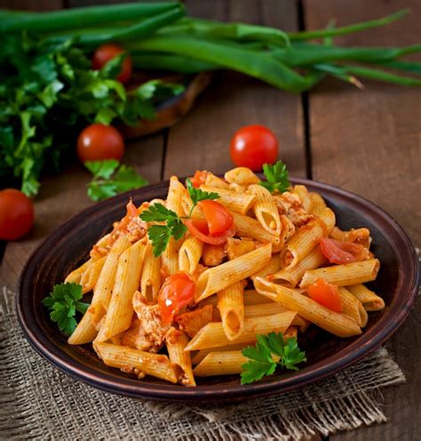 Premium Photo Penne Pasta In Tomato Sauce With Chicken And Tomatoes