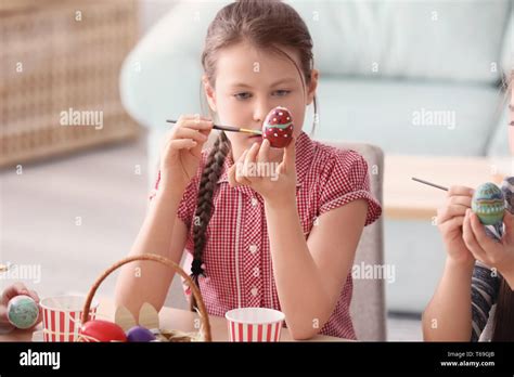 Cute Little Girl Painting Eggs For Easter At Home Stock Photo Alamy