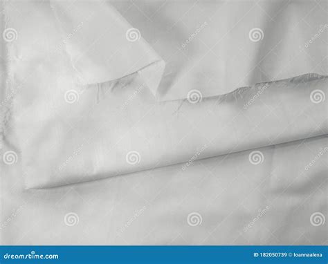 White Cotton Fabric With Pleats And A Tattered Cutted Edge Stock Image