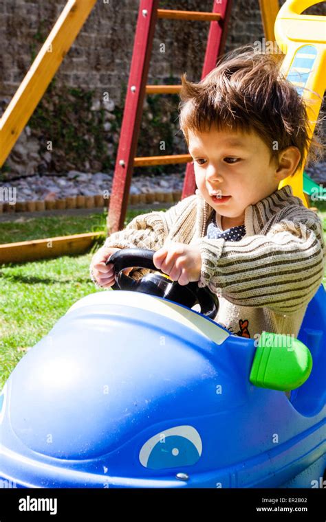 Young Child Boy 3 5 Year Old Driving In Play Peddle Car In A Garden